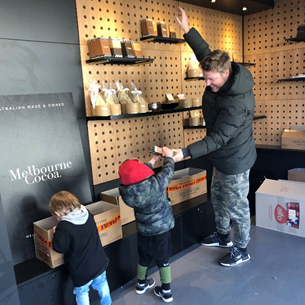 Sometimes it's all hands on deck - our kids helping Rich set up a store for Melbourne Cocoa