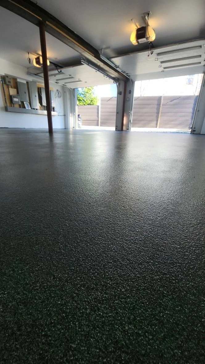 Wide view of finished epoxy flake garage floor in an empty garage, Trumbull, CT epoxy coating project
