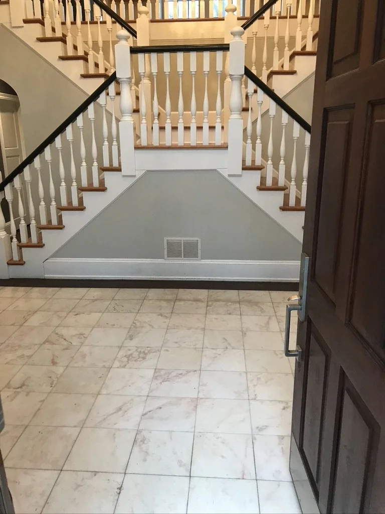 The same staircase hall before, with a tile floor, in a Fairfield, CT home