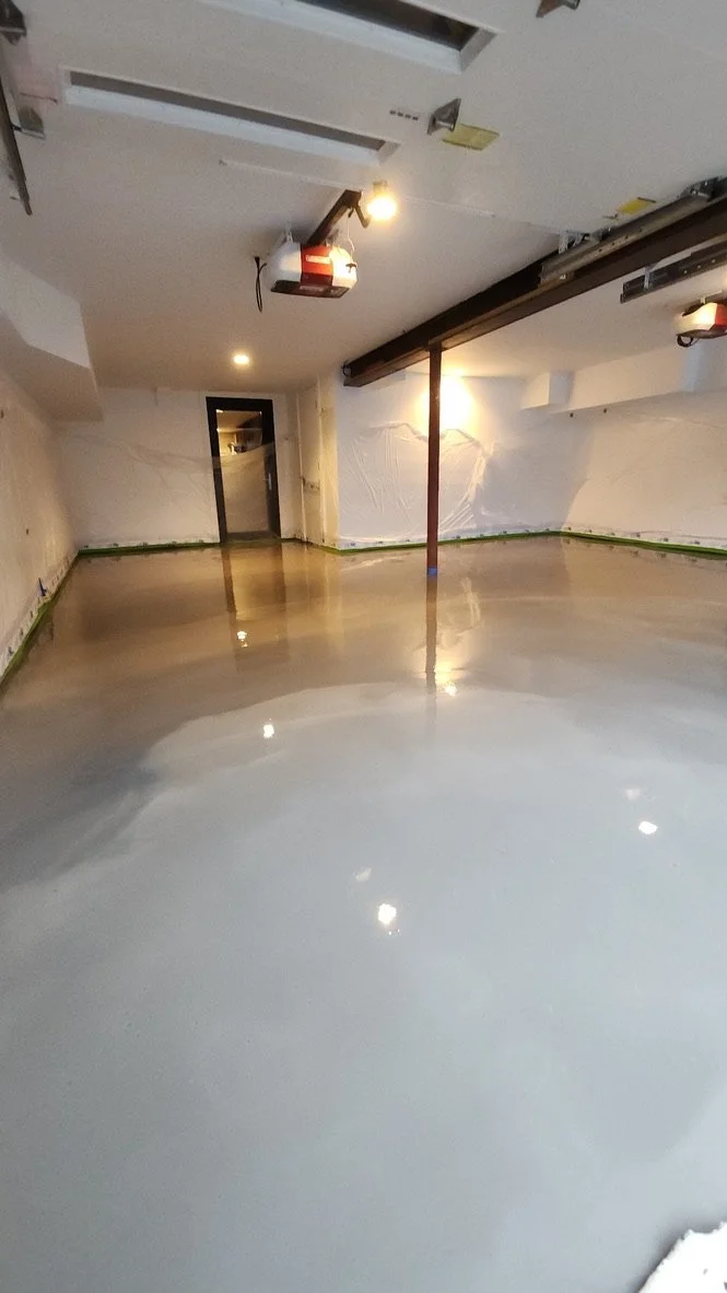 Wet grey epoxy base coat being applied to a garage floor during a coating project in Trumbull, CT