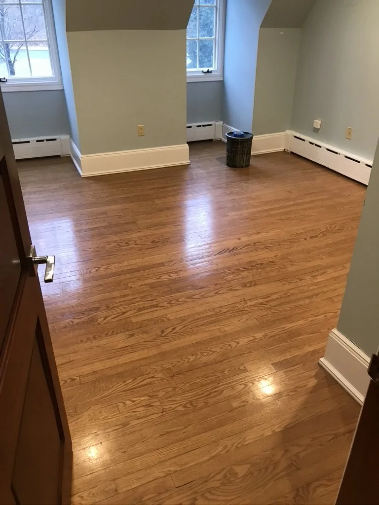 Bay-window room with an old amber oak floor before refinishing, Fairfield, CT