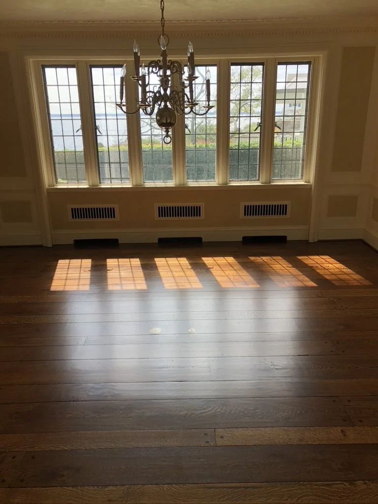 Refinished oak floor with a dark stain in a bright side room, Stamford, CT