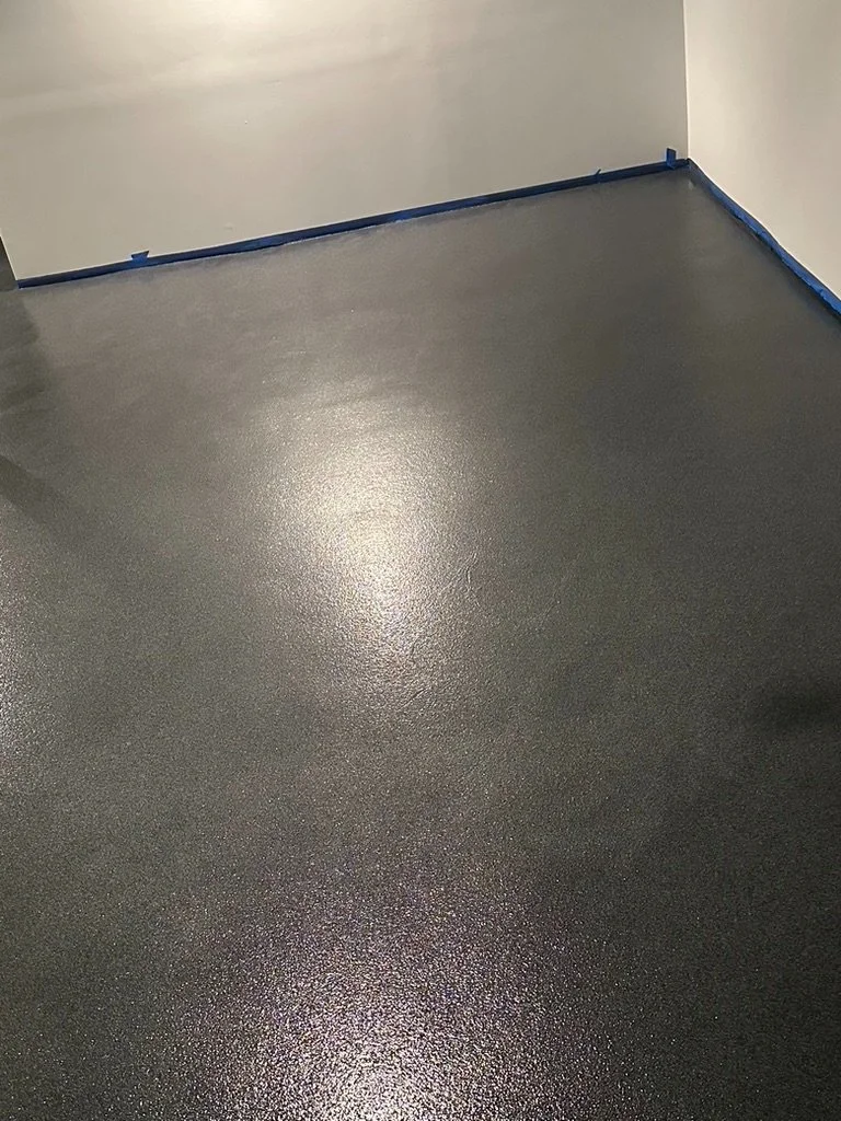 Close-up of finished epoxy flake flooring texture along a garage wall edge, Trumbull, CT