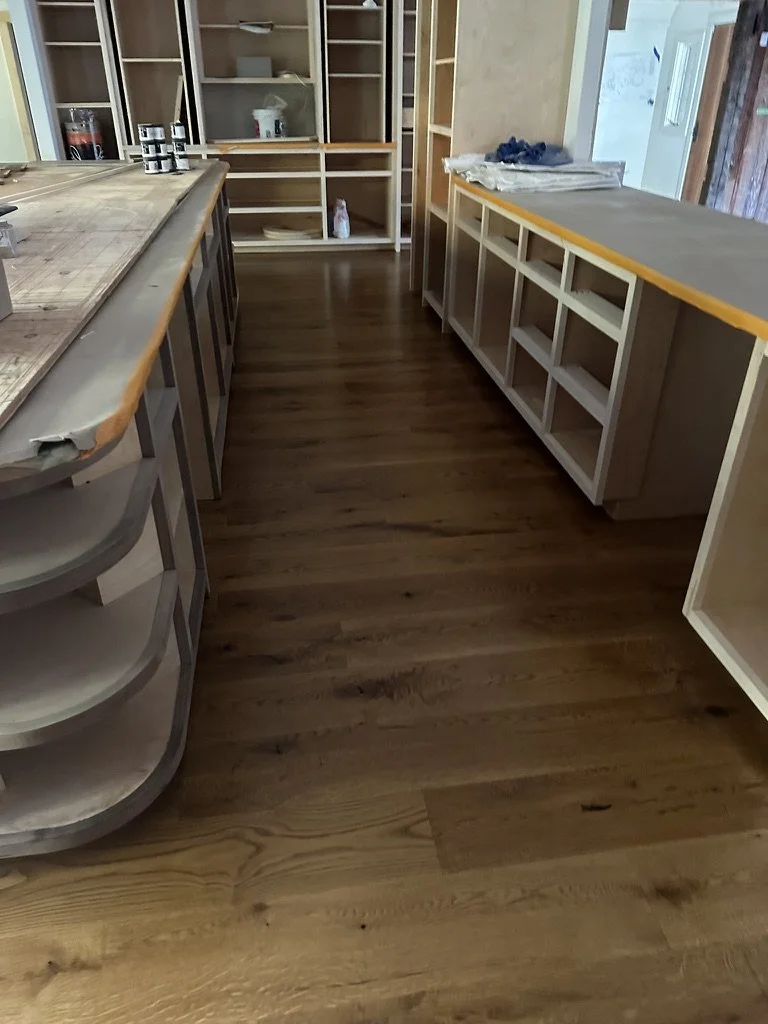 Dark stained wide-plank oak floor in a Weston, CT home office under construction with built-in shelving