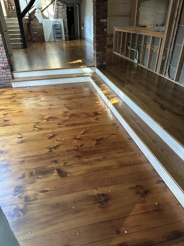 Medium brown stained character-grade white oak floor in a sunlit Weston, CT living room during renovation