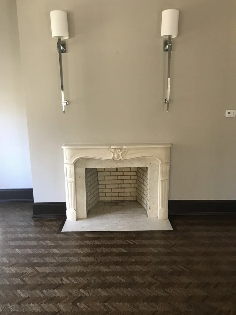 Dark-stained herringbone floor in front of a stone fireplace, Fairfield, CT