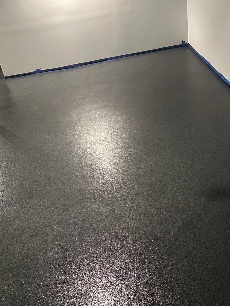 Close-up of finished epoxy flake flooring texture along a garage wall edge, Trumbull, CT