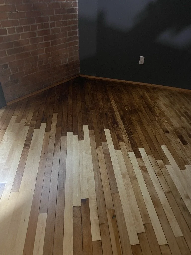 New hardwood boards woven into an old warehouse floor during a repair, Norwalk, CT