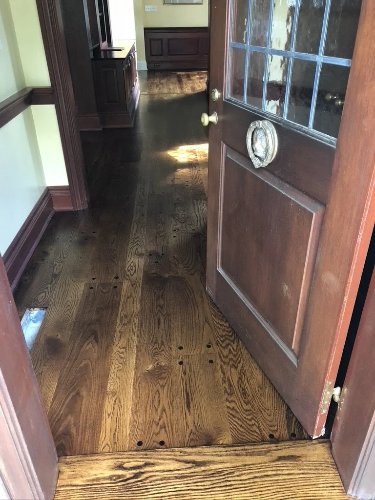 Refinished oak floor with a dark stain in a bright side room, Stamford, CT