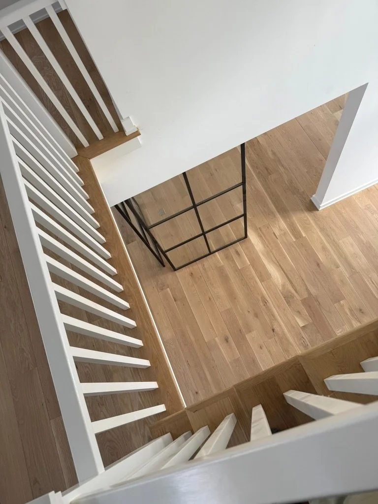 Wide-plank white oak hardwood flooring running the length of a hallway in a Danbury, CT home