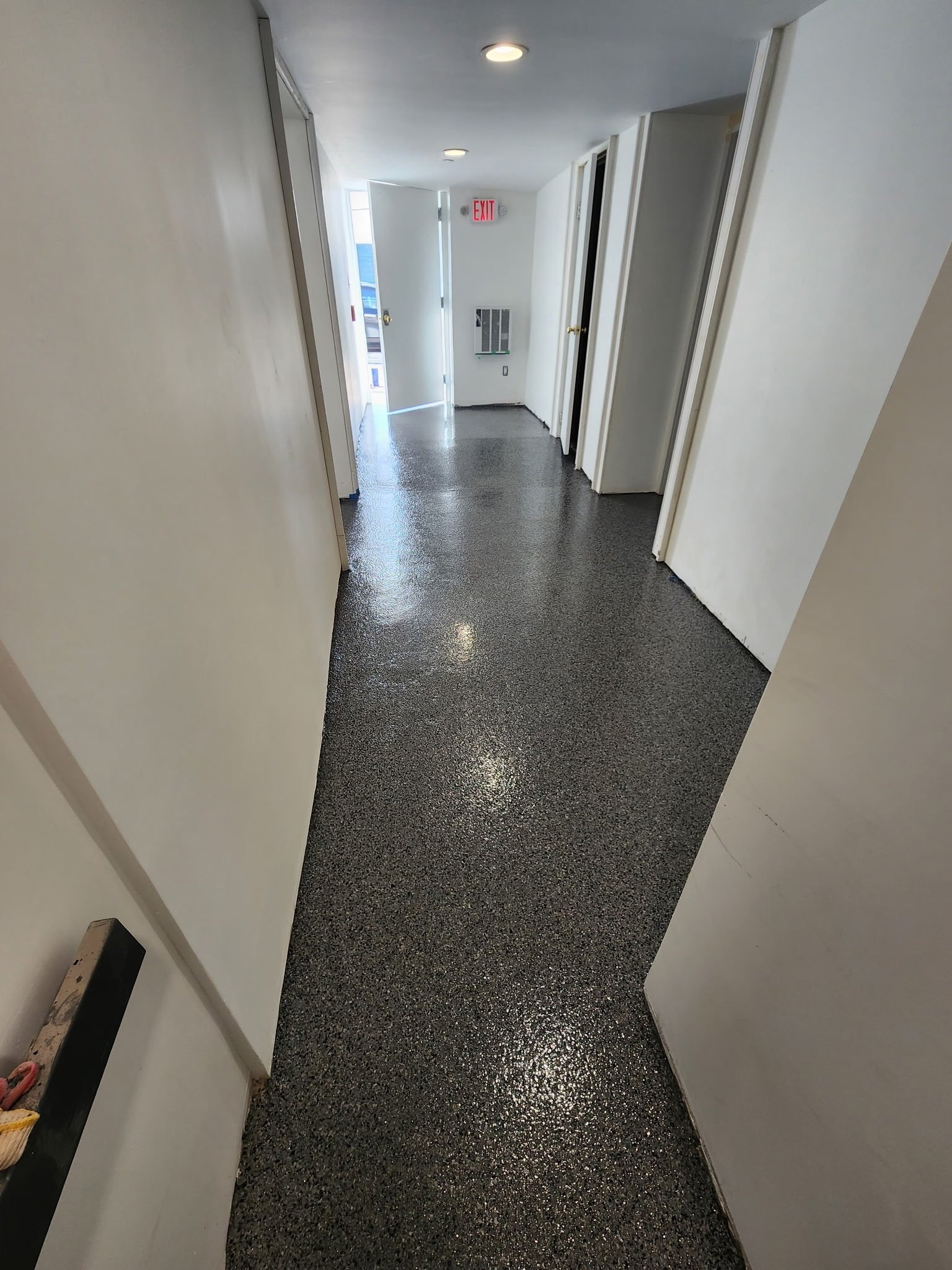 Finished gray, black, and white flake epoxy basement corridor, Danbury, CT