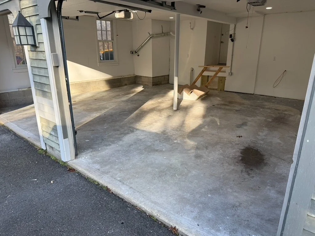 Stained and cracked concrete garage floor before epoxy flake coating, Weston, CT