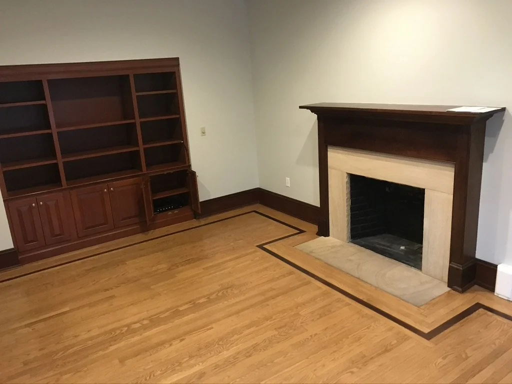 Living room oak floor with an old amber finish and a dark border before refinishing, Fairfield, CT