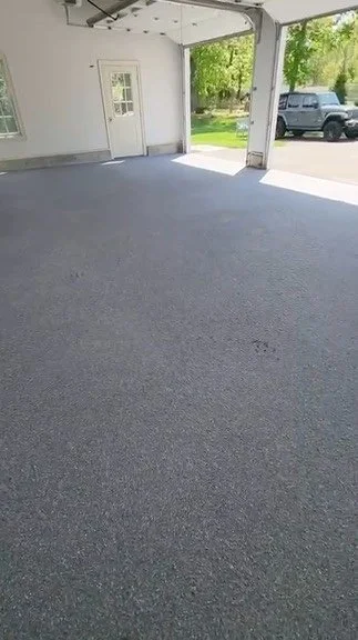 Interior view of a finished grey and black epoxy flake garage floor, Stamford, CT epoxy flooring project