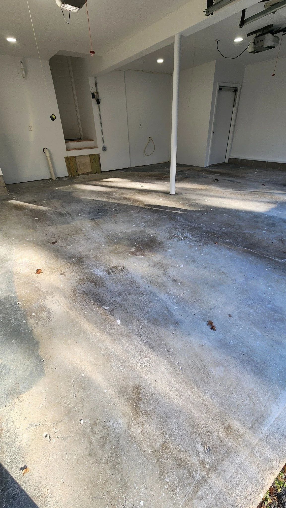 Stained and cracked concrete garage floor before epoxy flake coating, Weston, CT