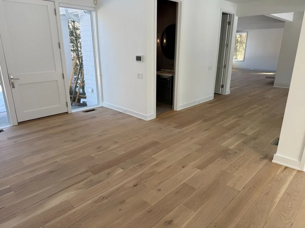 Wide-plank white oak hardwood flooring running the length of a hallway in a Danbury, CT home