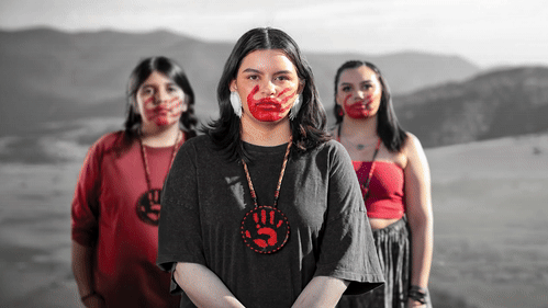 MMIP-3 people looking at the camera with a hand print on their face