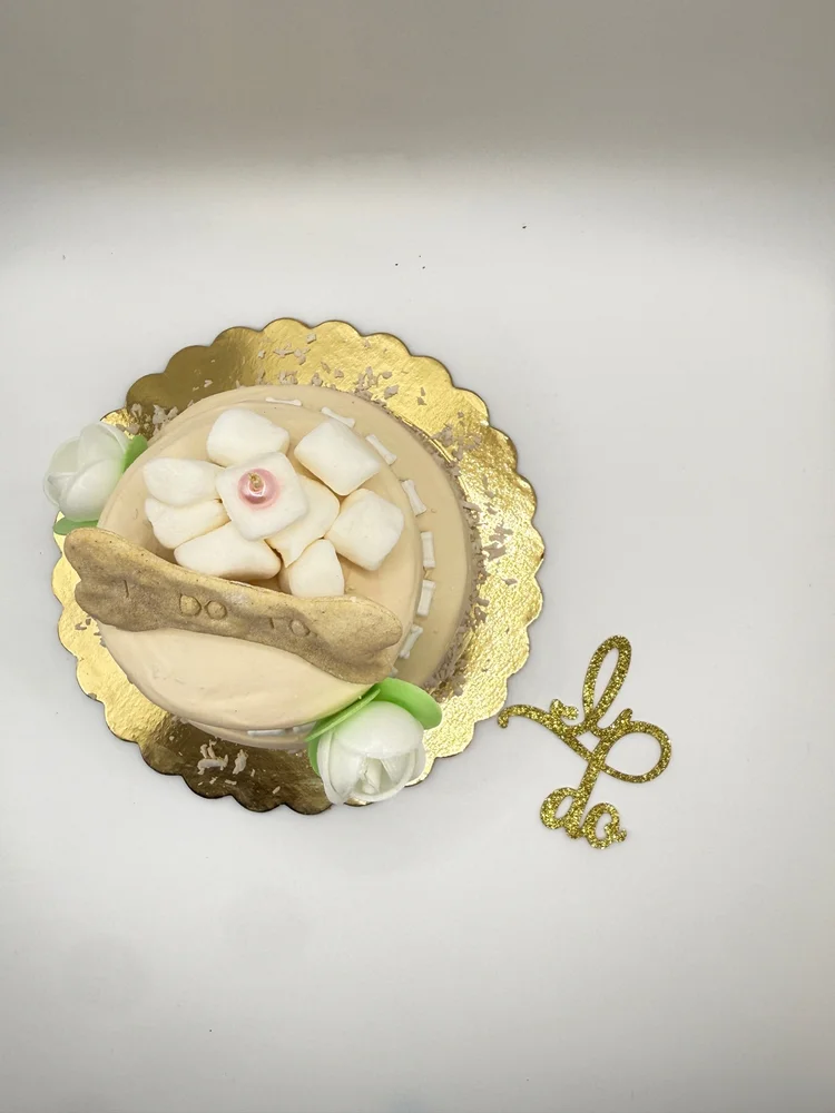 Dog Eat Cake wedding cake with floral decorations and an I do topper