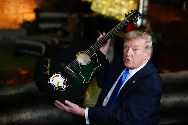 Trump Signs Elvis' Guitar