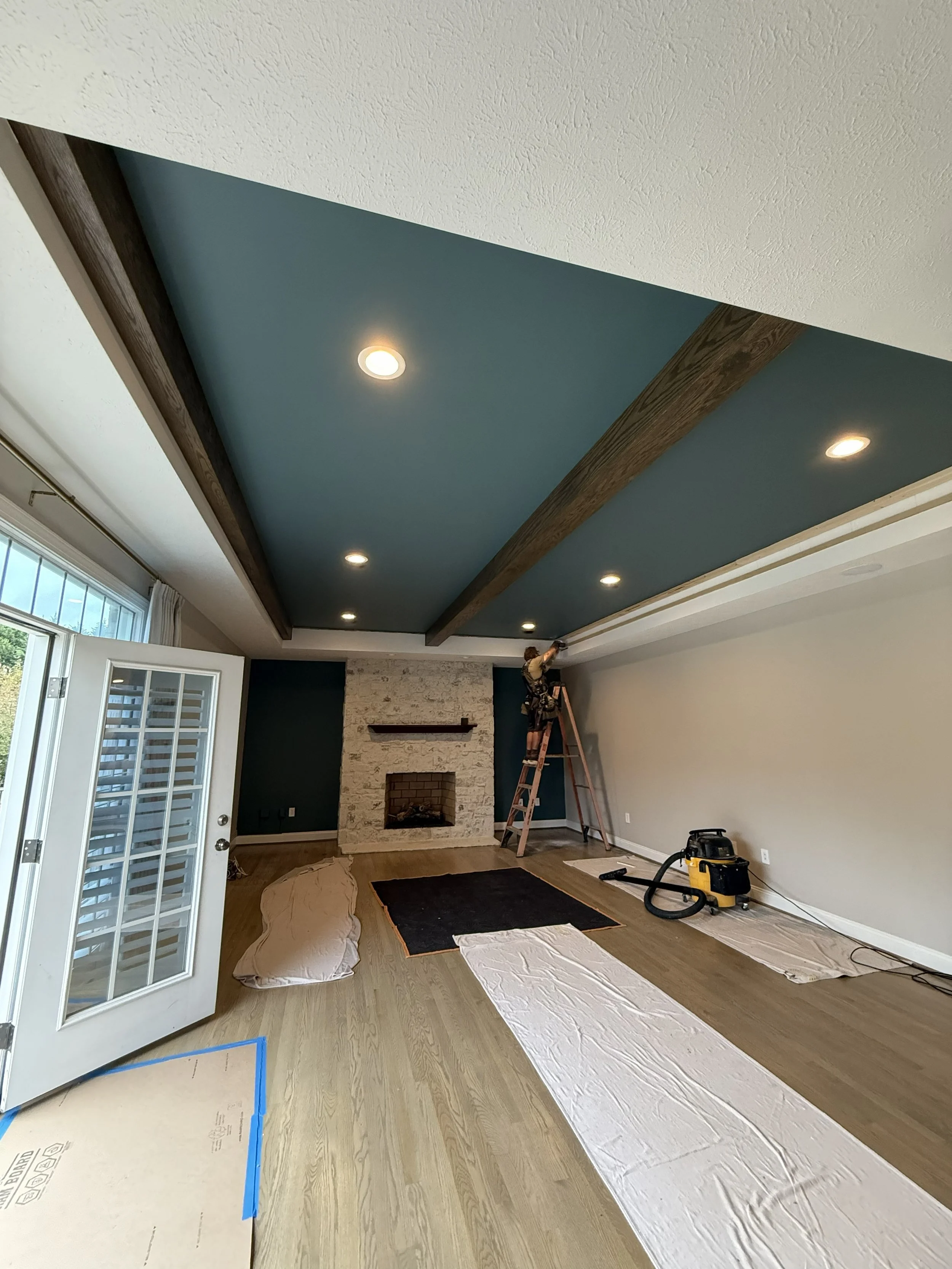 Installation of red oak beams in coffered ceiling