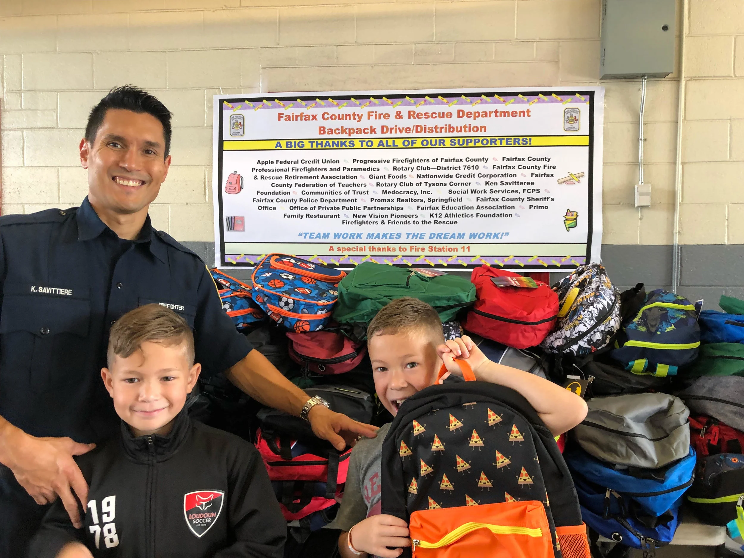 (Left to Right) Ken, Maks and Madden Savittiere at the Backpack Drive Aug. 2018