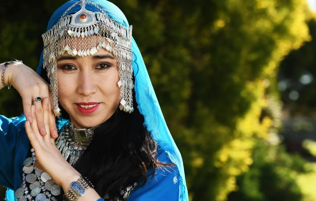 HOWCASING FASHION: Saira Ali says the traditional outfit for women from Afghanistan comprises of so many parts, but as the jewellery is all silver it does not weigh too much. Decked out in jewellery and wearing an embroidered three-piece outfit, the traditional dress from Afghanistan is sure to catch the eye. In recent weeks, The Daily Advertiser has been highlighting fashions from cultures that are thriving in the region, with women leading the way forward. Saira Ali, 27, came to the Riverina in 2015 after fleeing Afghanistan. "We have found Wagga so friendly," she said. "We have made many new friends who encourage and teach us to learn English. "They are always helping us to improve." Ms Ali works full-time at a sewing shop after learning crucial skills with the Common Threads group run by the Multicultural Council. She said generally traditional women's dresses in Afghanistan are made from light linens and are loose fitting to allow ease of movement. "They come in many colours and have stitching," Ms Ali said. The traditional colour is blue."