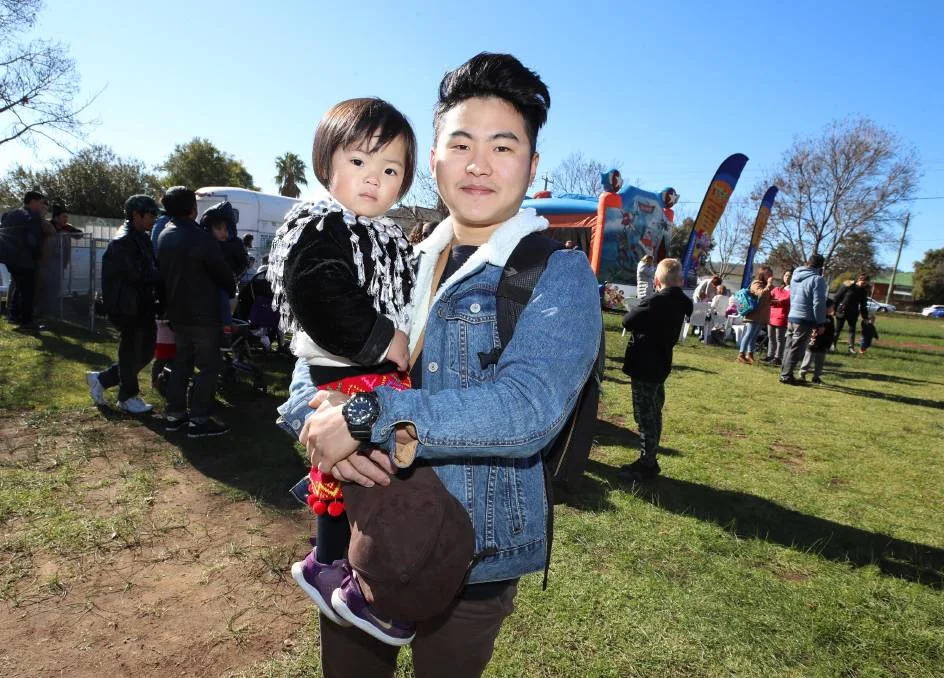 Phong Tiwangce with his sister Grace Tiwangce, 2, at the Refugee Week Family Fun Day. Picture: Les Smith FORCED to flee his home country to survive, one Burmese refugee says he has been welcomed into the Wagga community. During the weekend's Refugee Week community celebration at Henschke Primary School, Phong Tiwangce told of how he arrived in the city when he was 12 years old. "My mum and dad and I had to flee Burma because we feared for our lives," he said.