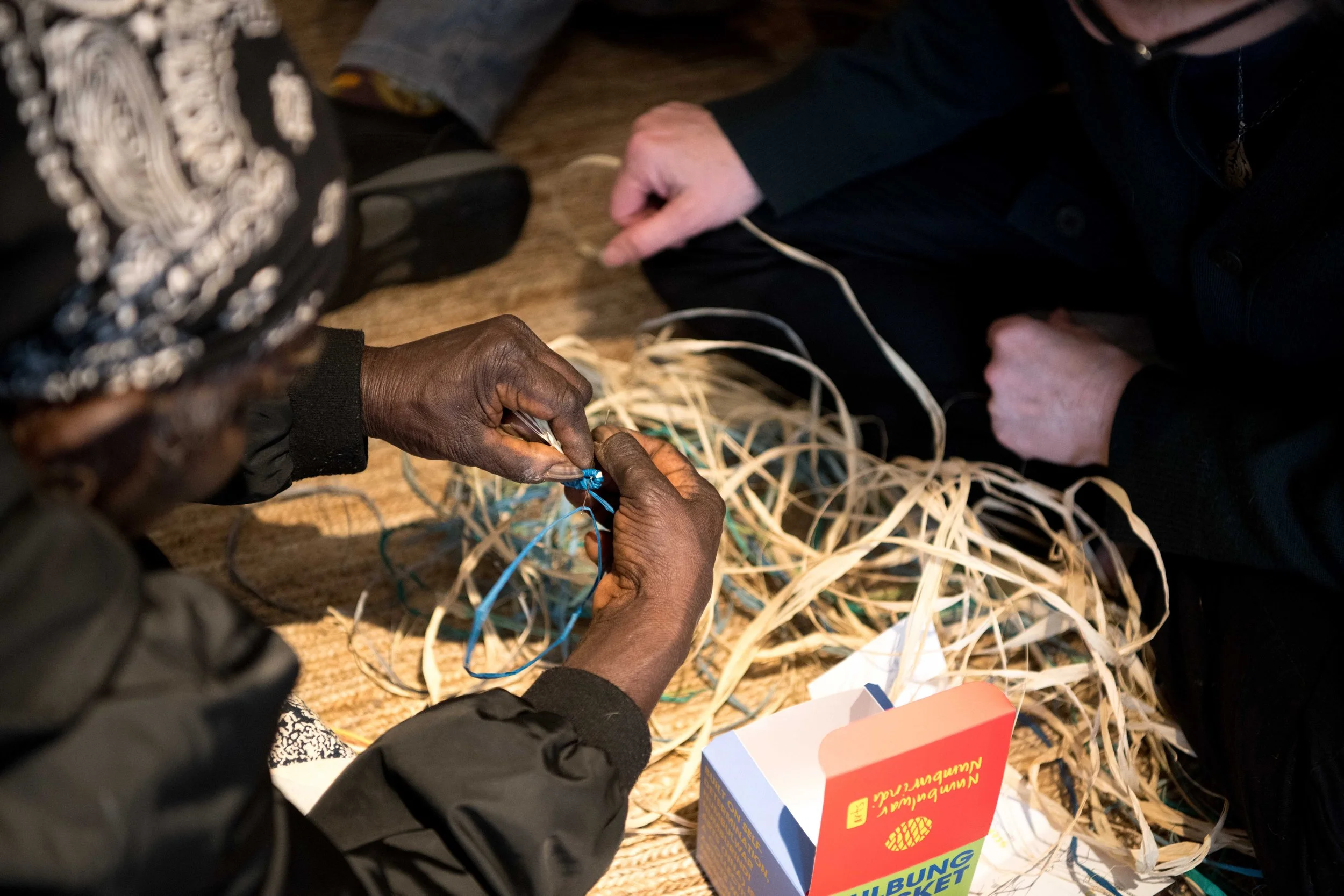 1 Joy Wilfred leading a weaving circle at TAIT Melbourne for Melbourne Design Week 2023. Photo courtesy of Numbulwar Numburindi Arts.jpg