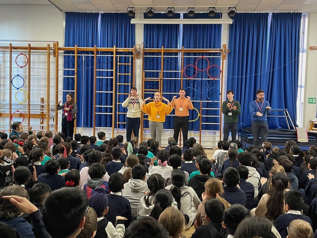 Over the last two weeks, our Education Leaders have been on our first-ever Assembly Tour around nine primary schools across Tower Hamlets and Hackney in London. 

Around 700 children took part in workshops, learning how to warm up their voices with a