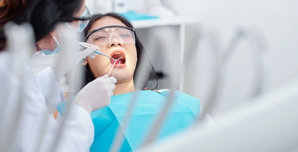 woman in dental chair being treated by dentist