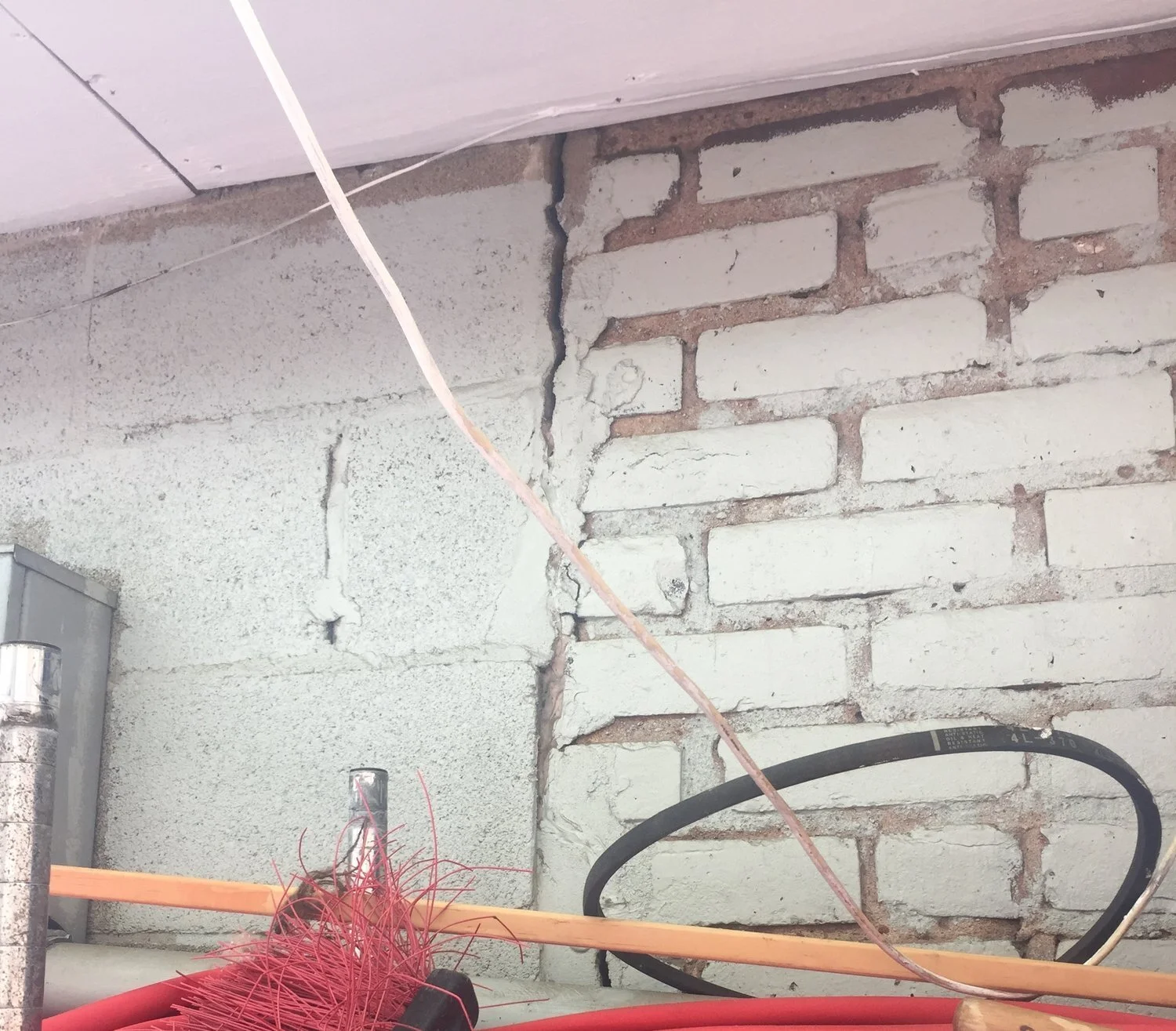 The bricks beneath the sheetrock of an exterior wall belonging to Sabor Unido, one of the restaurants featured in the Foodscapes project, reveal generations of turnover in the Ironbound’s immigrant residents. Photo credit: Gulse Eraydin