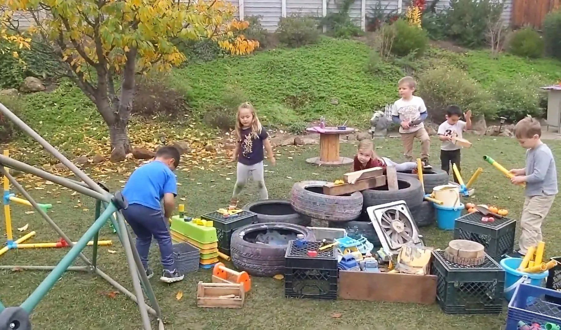 Whole-group collaboration on the construction and use of a pretend "movie theater."