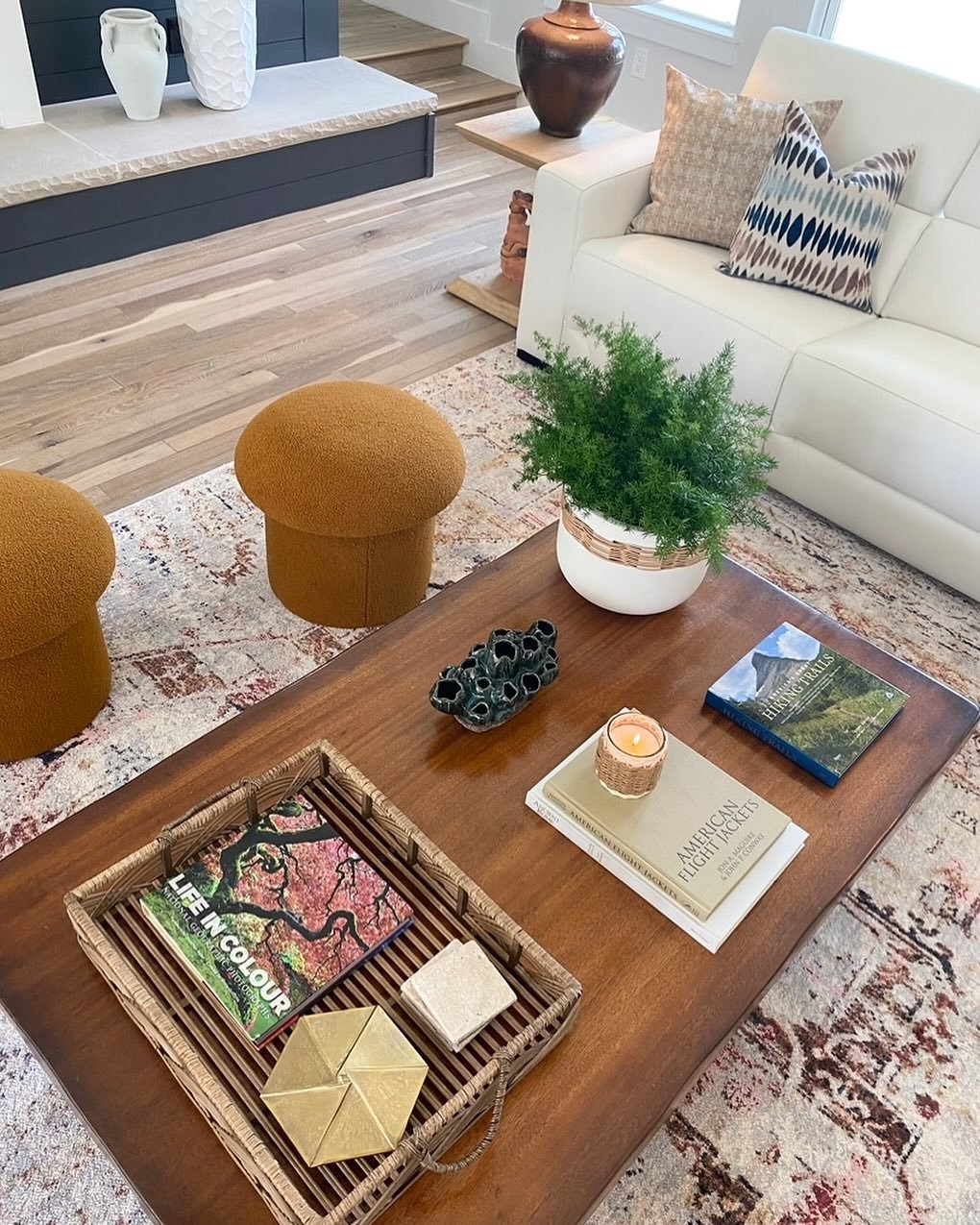 Coffee table styling is such fun! It&rsquo;s a place you can layer meaningful objects, books or collections that create conversation. A tray whether it is rattan, acrylic, or wood is always a great way to create those design layers.  It also makes it