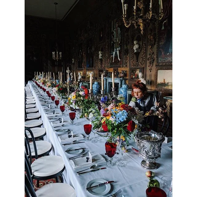 What a week we had at Petworth house to prepare for the wedding of George and Cruz. Our journey there started early this year meeting with the gardeners and planning what to plant for the day, then cutting the abundance of beautiful flowers, vegetables and fruits that they grew to fill 8 rooms with completely different designs. The table design in this room was inspired by the incredible Grinling Gibbons carvings from the early 1690&rsquo;s that fill the walls of the carved room (which is also the home of many Turner paintings) Cascading flowers, fruits, open pea pods, quail eggs and scented jasmine transformed the tables into beautiful still life scenes. The whole process was a collaboration with the beautiful bride herself @studio_cruz 🙏🏻
