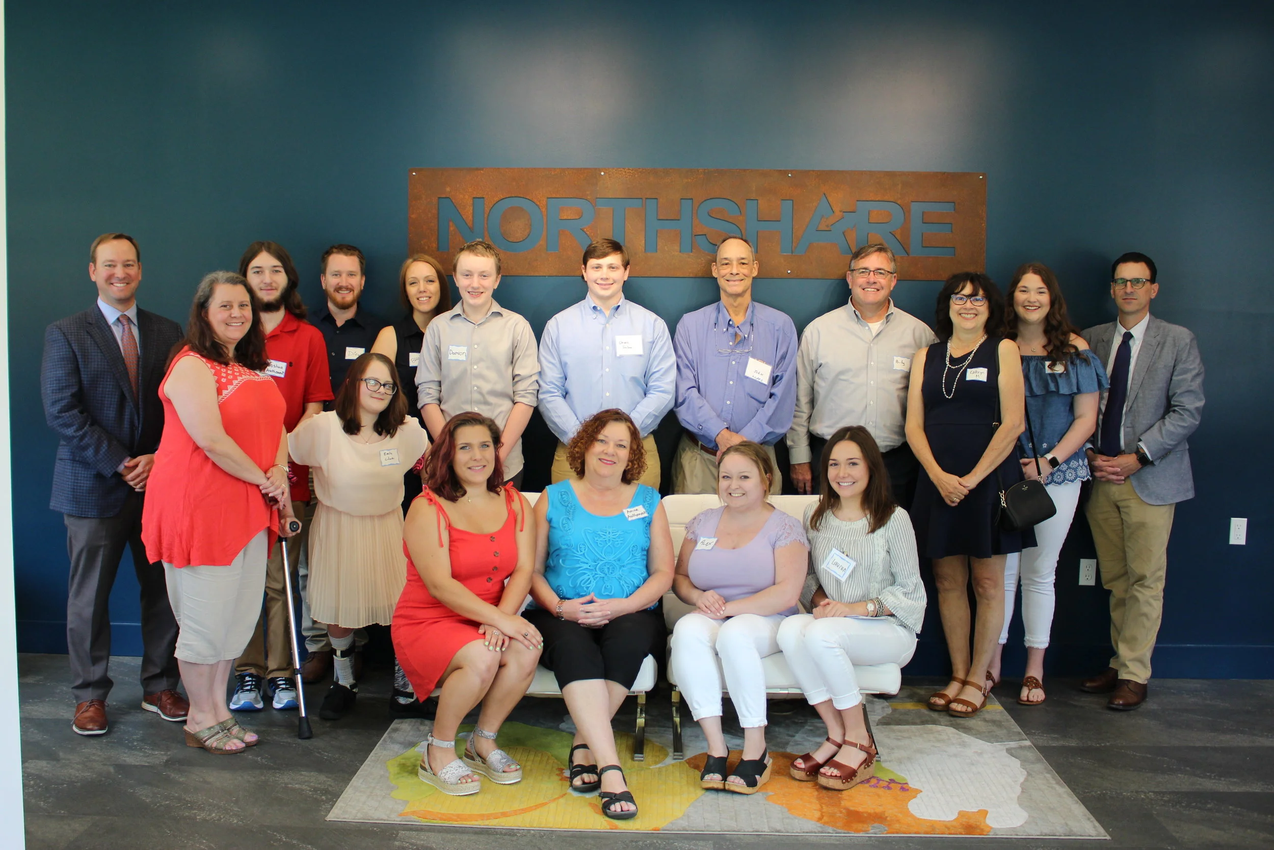 2018-2019 Scholarship Recipients and their families. Board members flank them on either side.