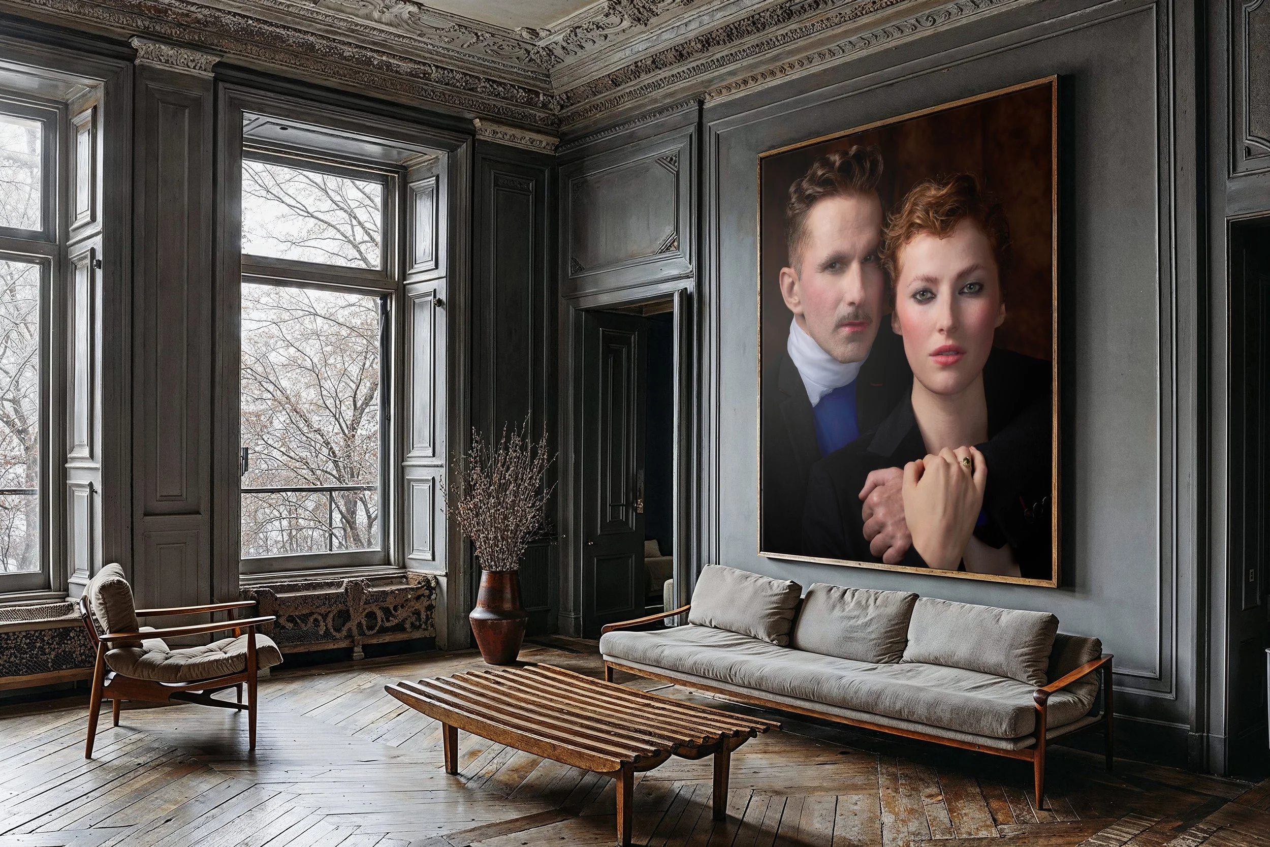 A stylish living room with dark wood paneling, large windows, and a large portrait of a man and woman hanging on the wall. The room features a modern sofa, vintage armchair, wooden coffee table, and a tall vase with dried branches.