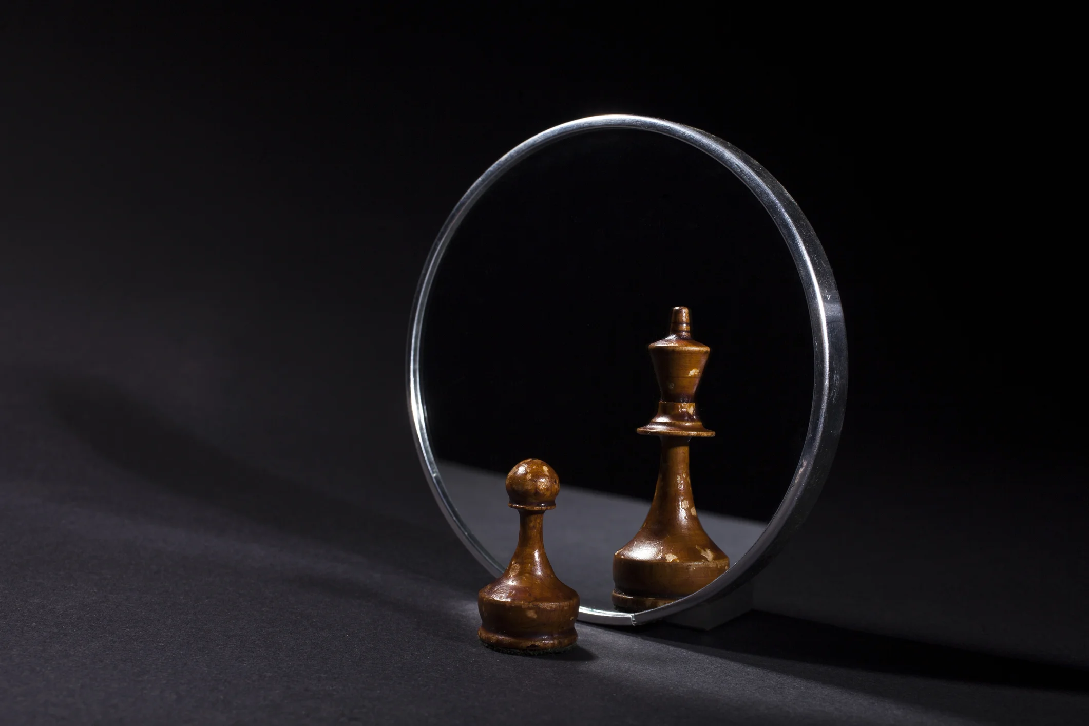 Chess piece in front of a mirror with the reflection showing