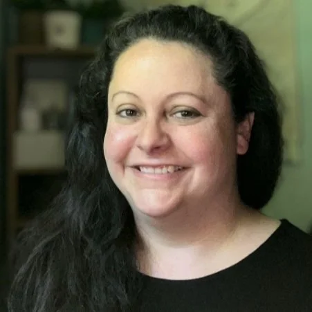 Caucasian woman with brown hair smiling at camera