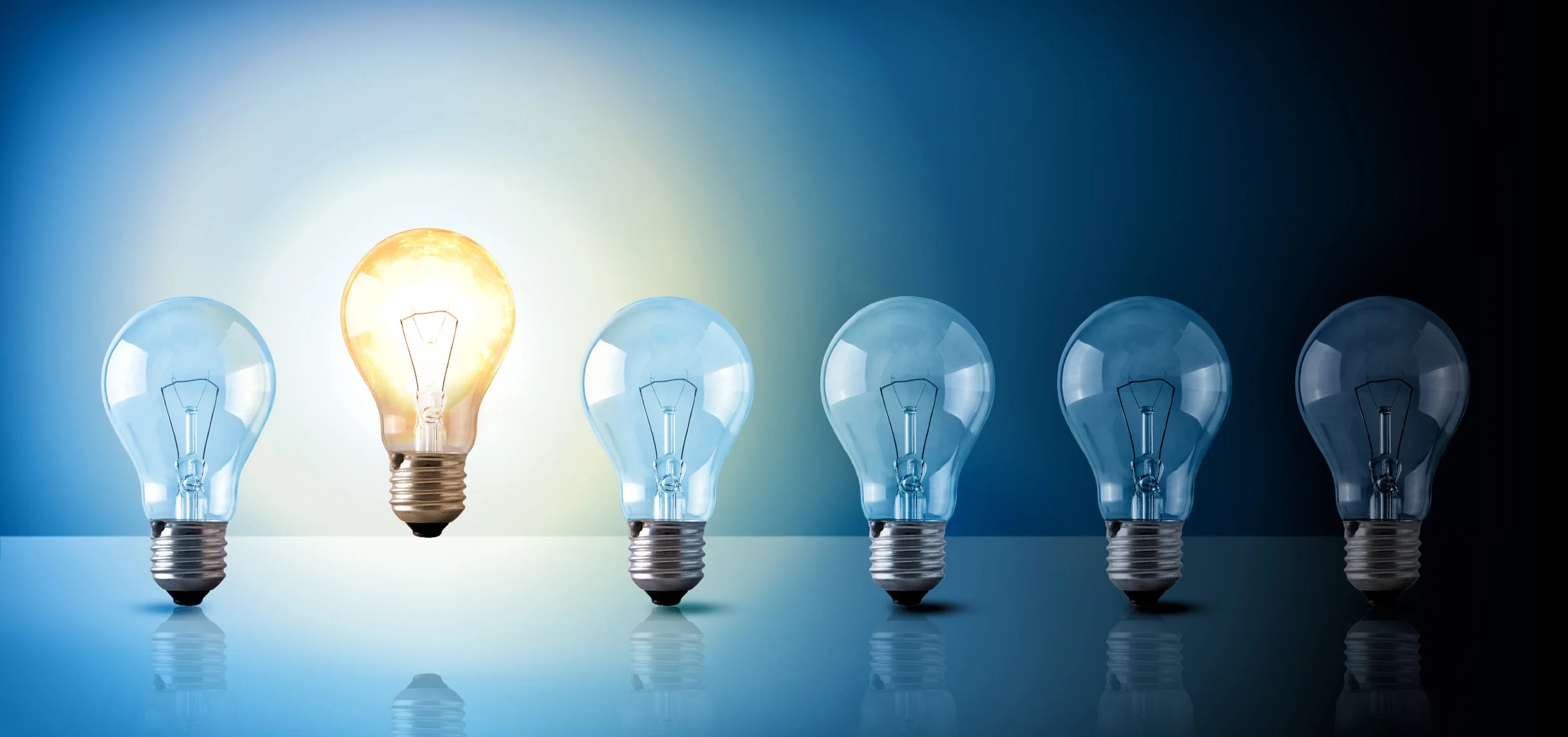 Idea concept with light bulbs sequence on blue background.jpg