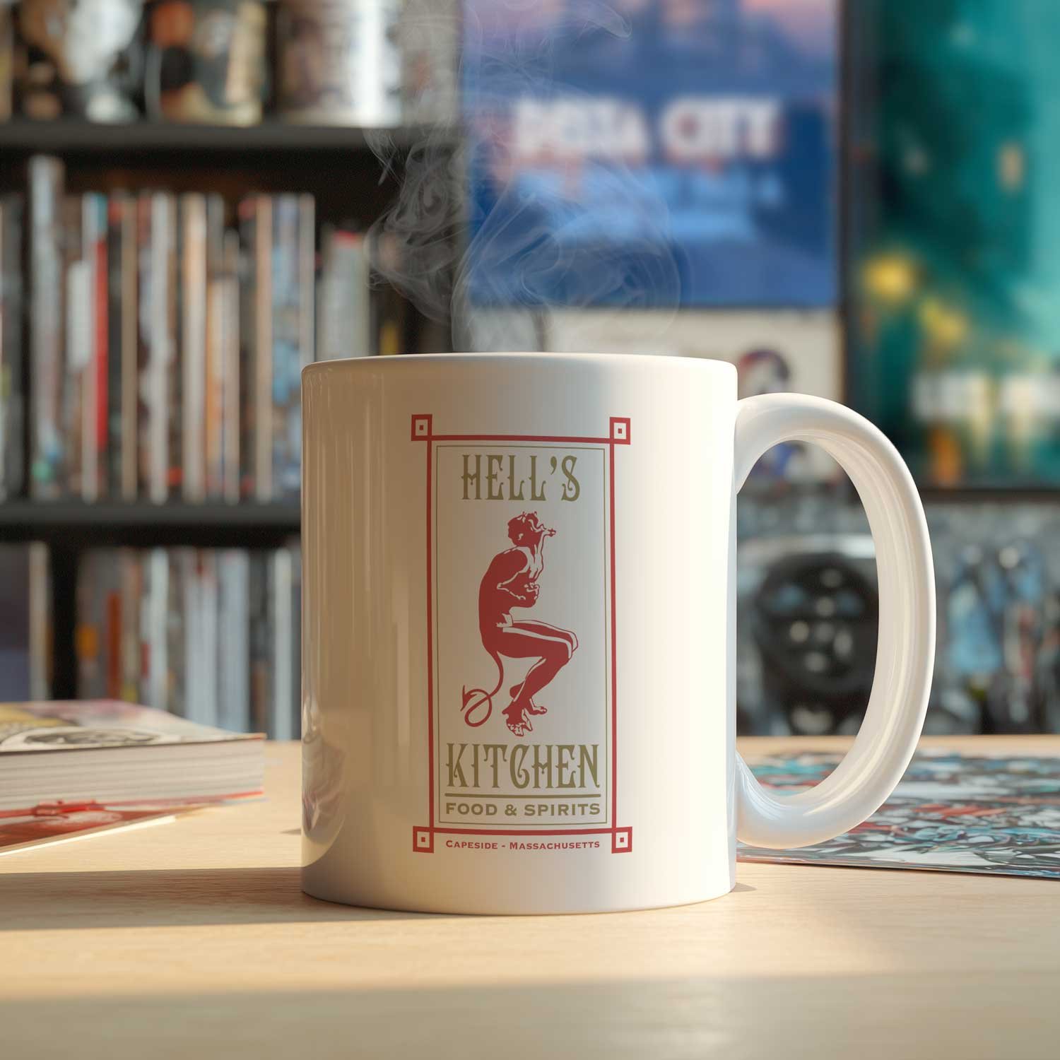 A Hell's Kitchen mug is displayed on a table, filled with coffee.