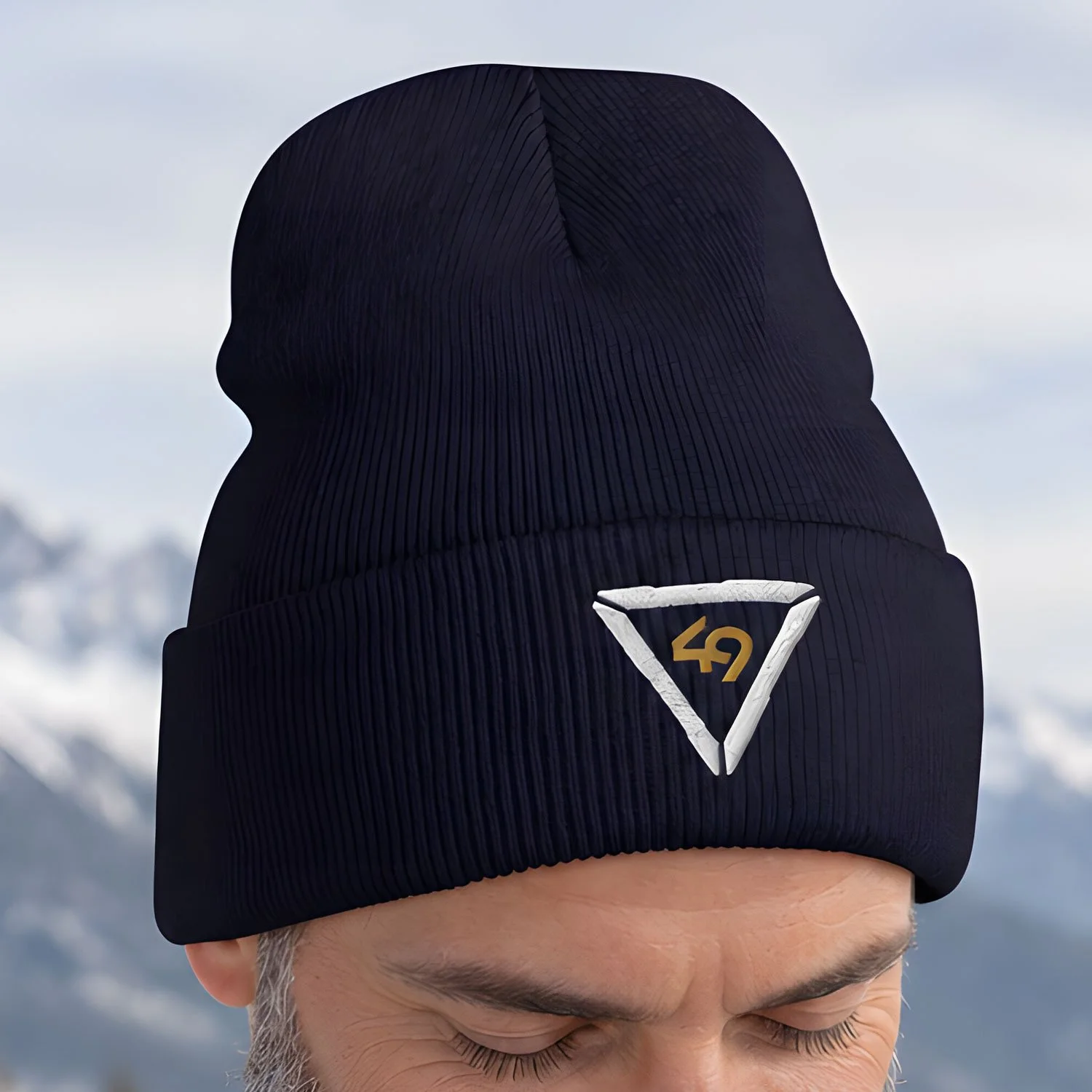 Image of a man wearing a Tech 49 beanie in a rugged landscape.