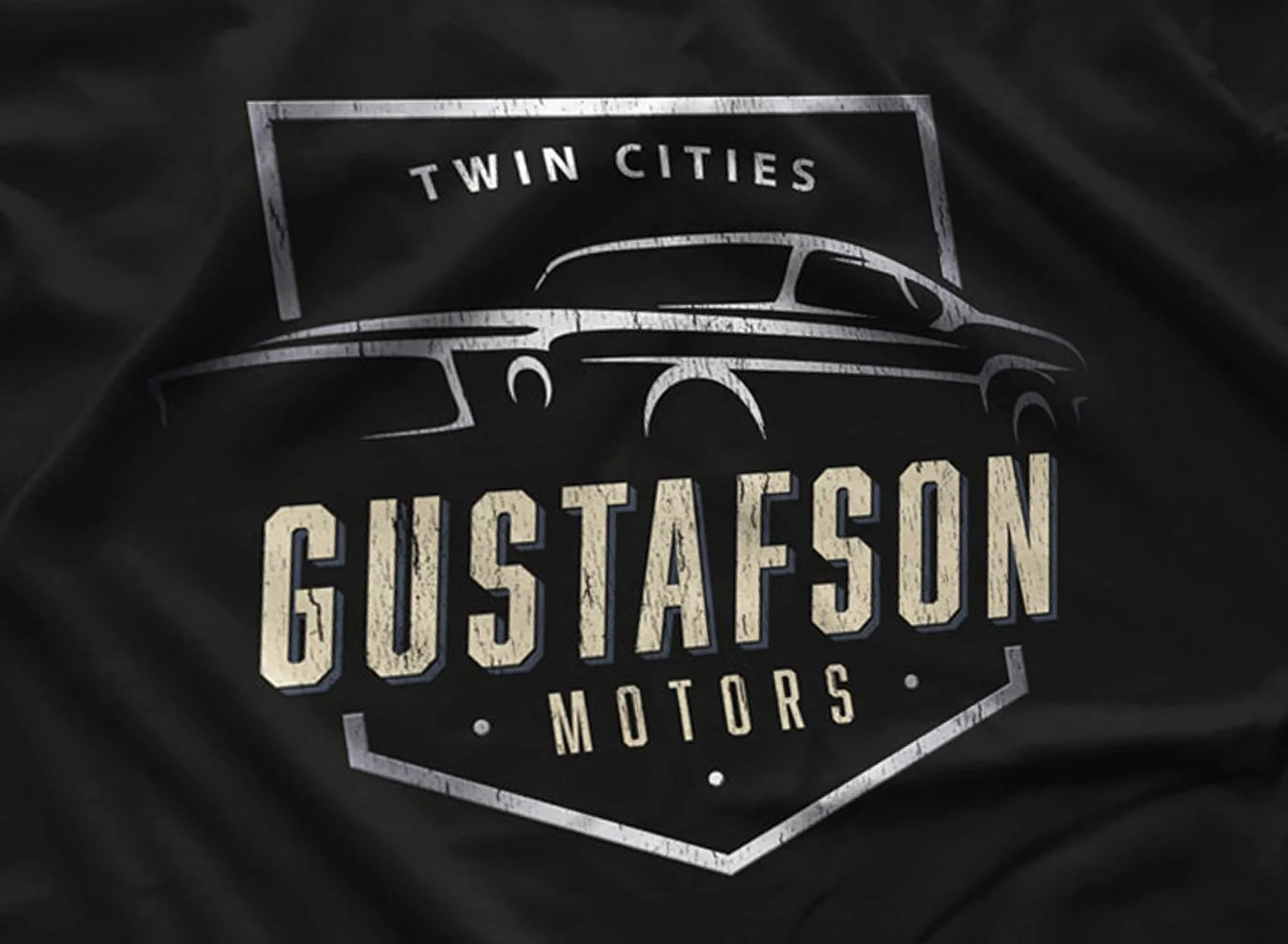 Close-up of a Gustafson Motors T-Shirt in Black.