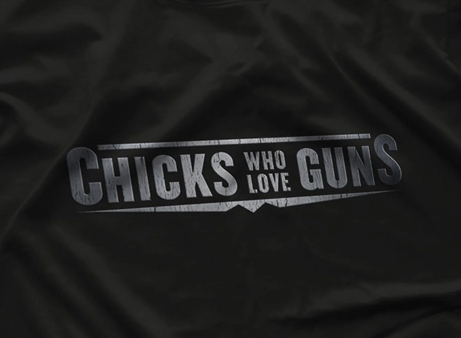 Close-up of a Chicks Who Love Guns T-Shirt in Black. Get your "Jackie Brown"- inspired shirt in sizes S to 5XL, starting at just $21.49 with free shipping.