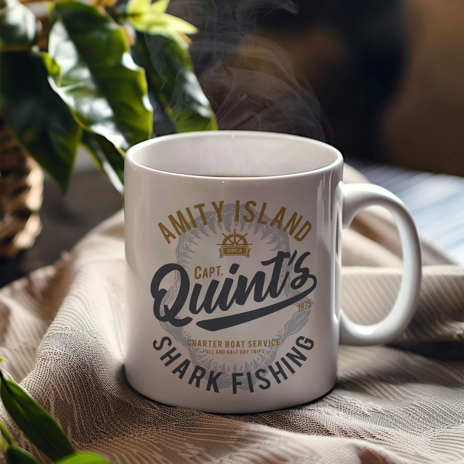 A Quint's Shark Fishing mug is displayed on a table, filled with coffee.