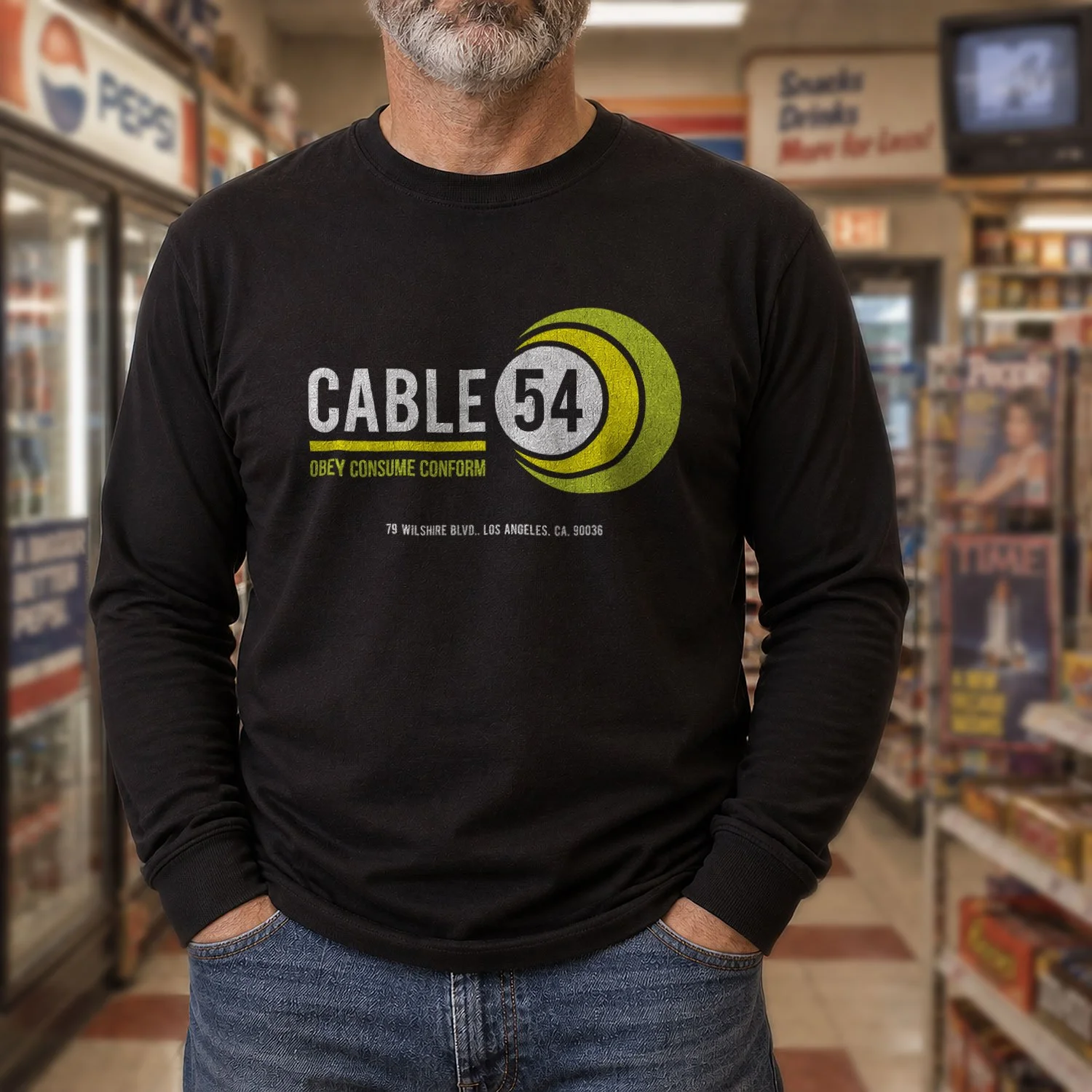 Image of a man wearing a Cable 54 long-sleeve T-shirt in a retro 1980s convenience store.