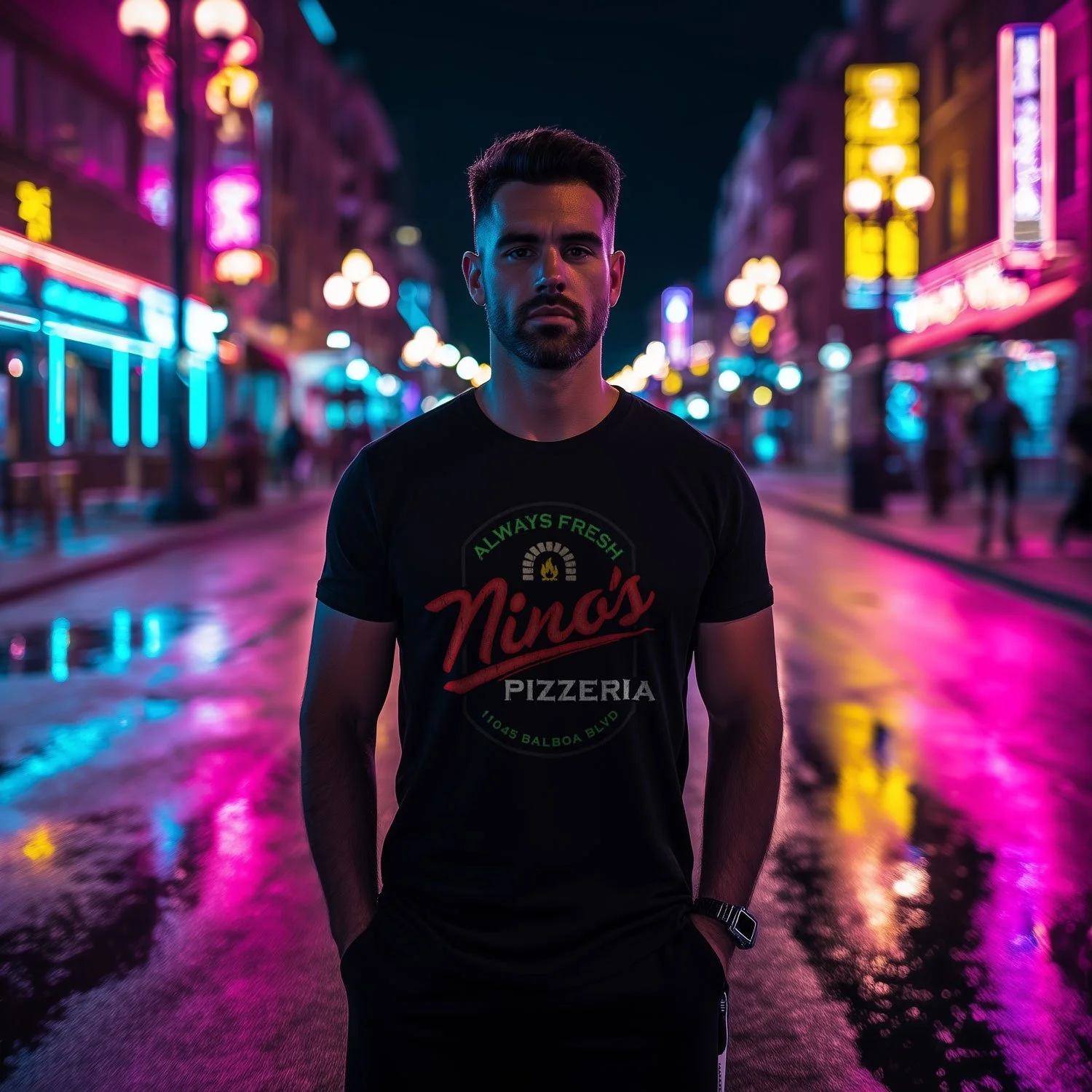 Image of a man wearing a Nino's Pizzeria T-shirt in Black on a neon-lit California street.