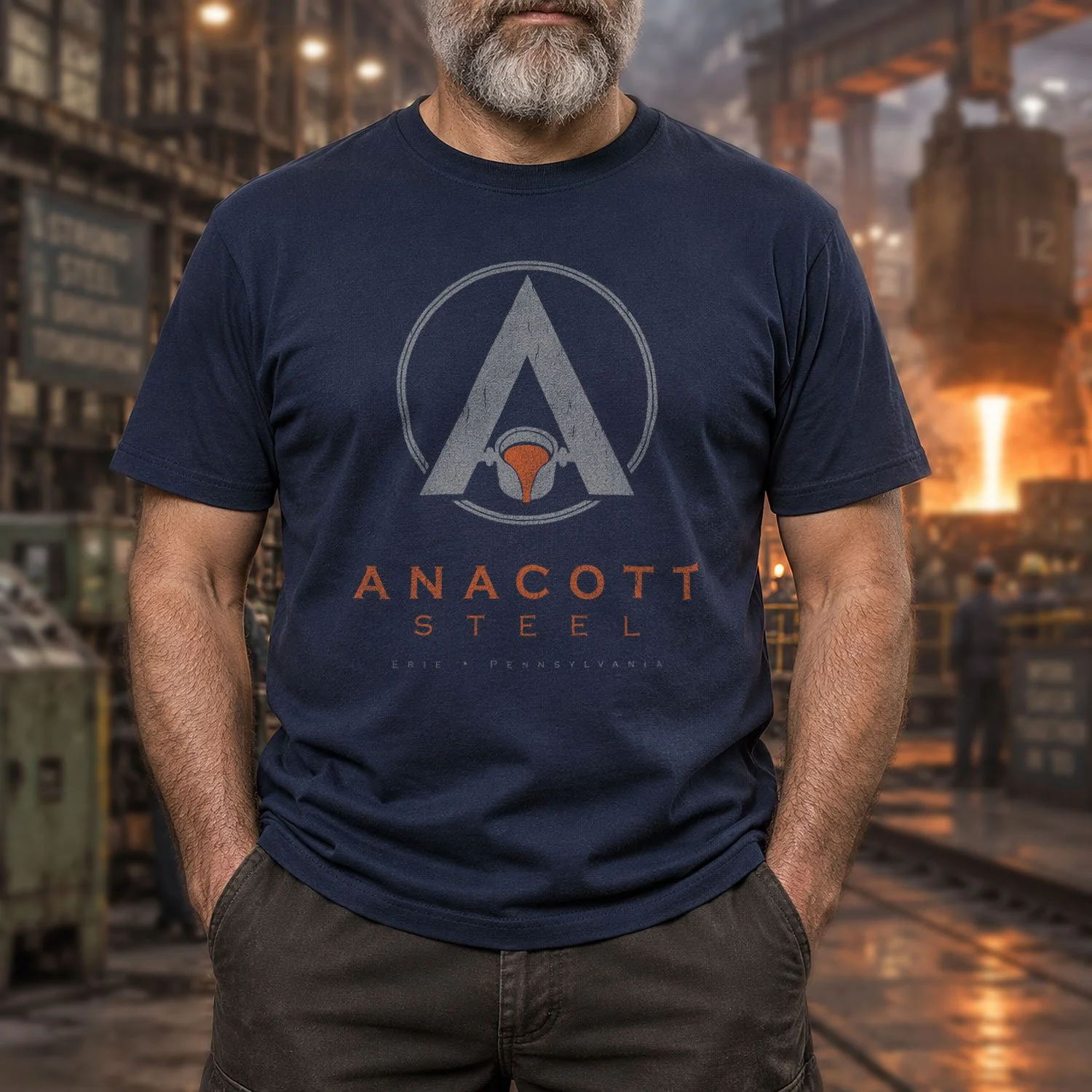 Image of a man wearing an Anacott Steel T-shirt in a rugged steel mill setting.