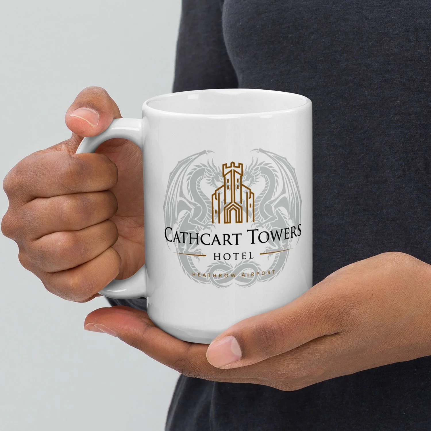 Close-up of a man holding a 15-oz Cathcart Towers Hotel Mug.