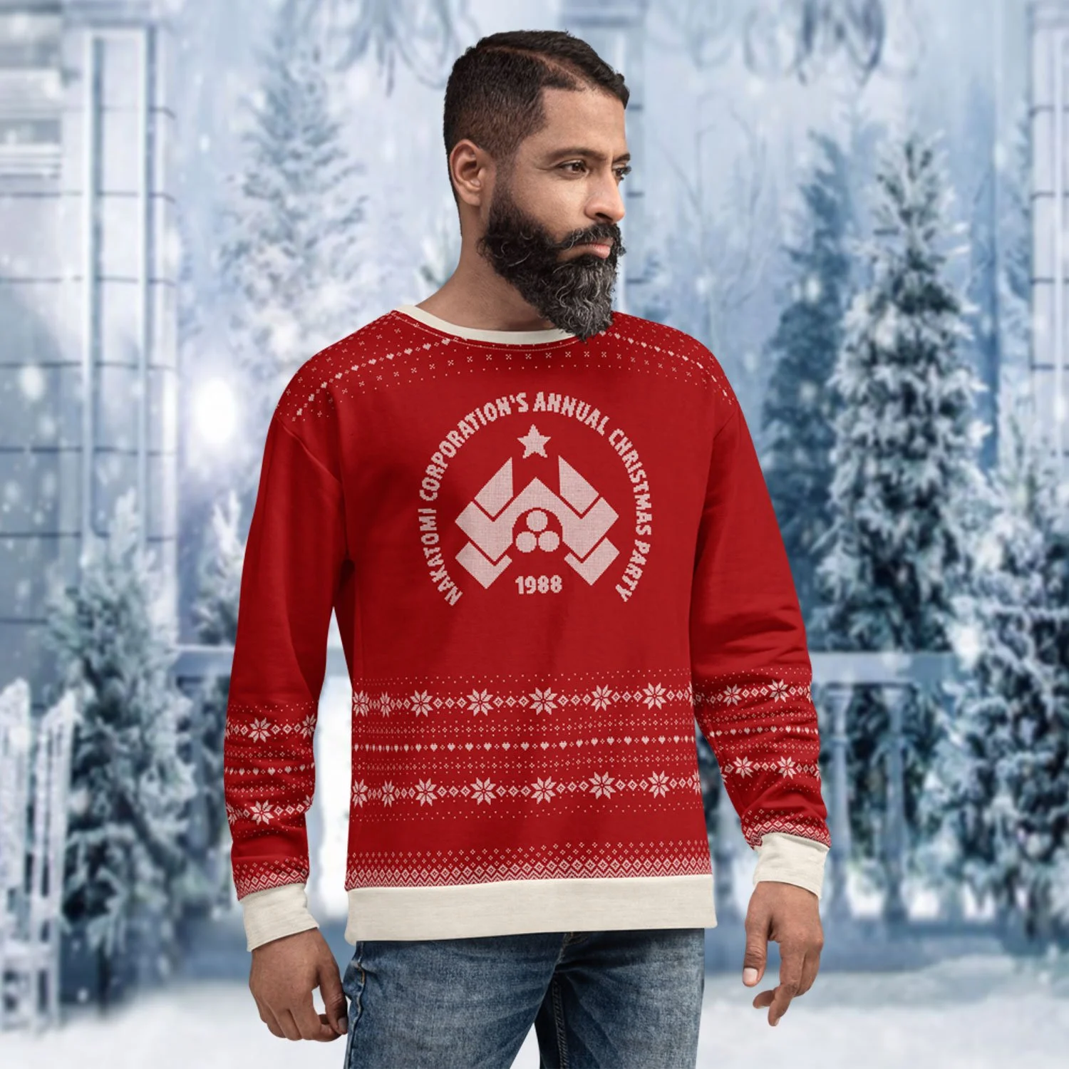 A male model is shown from the front wearing a 1988 Nakatomi Christmas Party Ugly Sweater sweatshirt, set against a snow-covered backdrop.