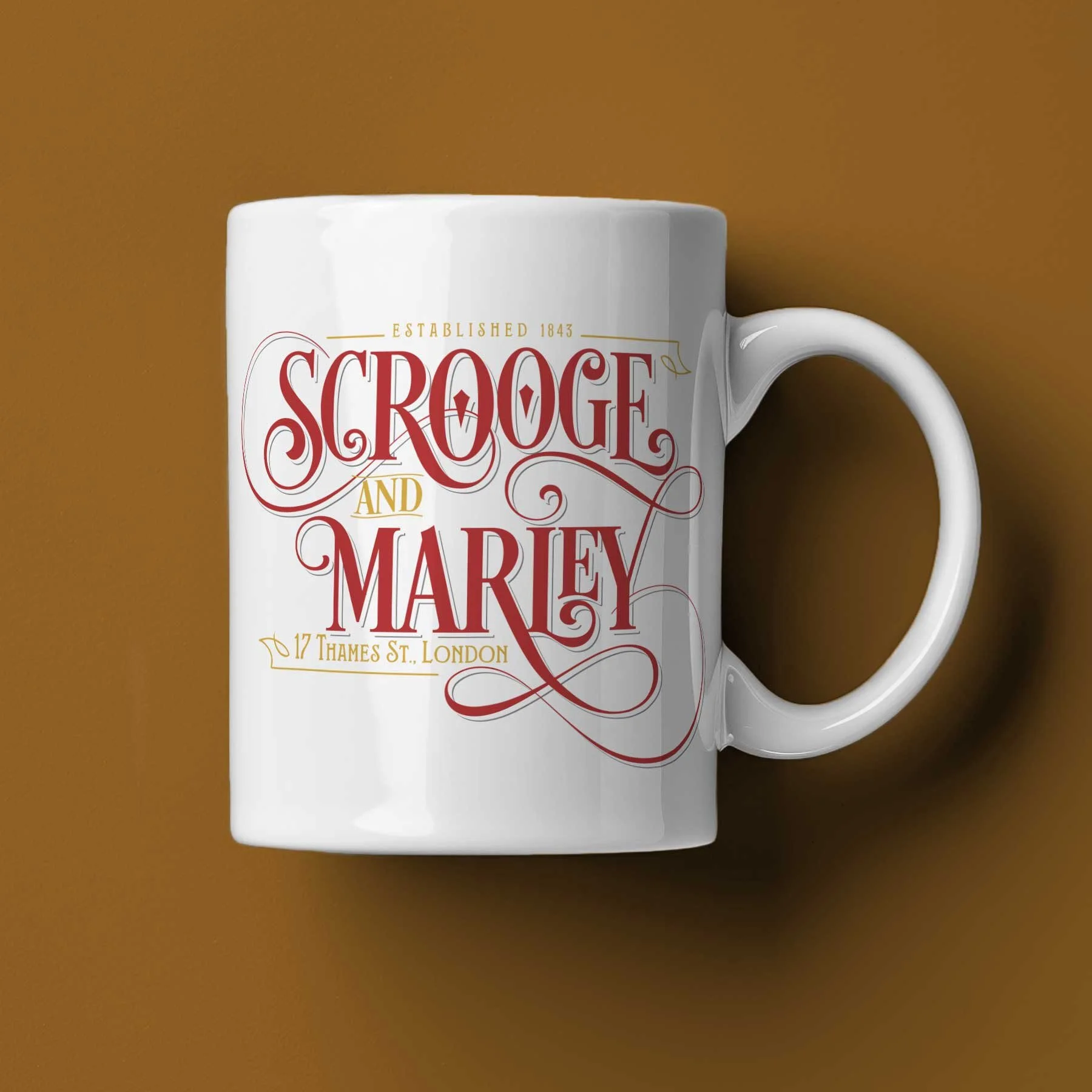 A Scrooge and Marley mug lying on its side on a dark brown background.